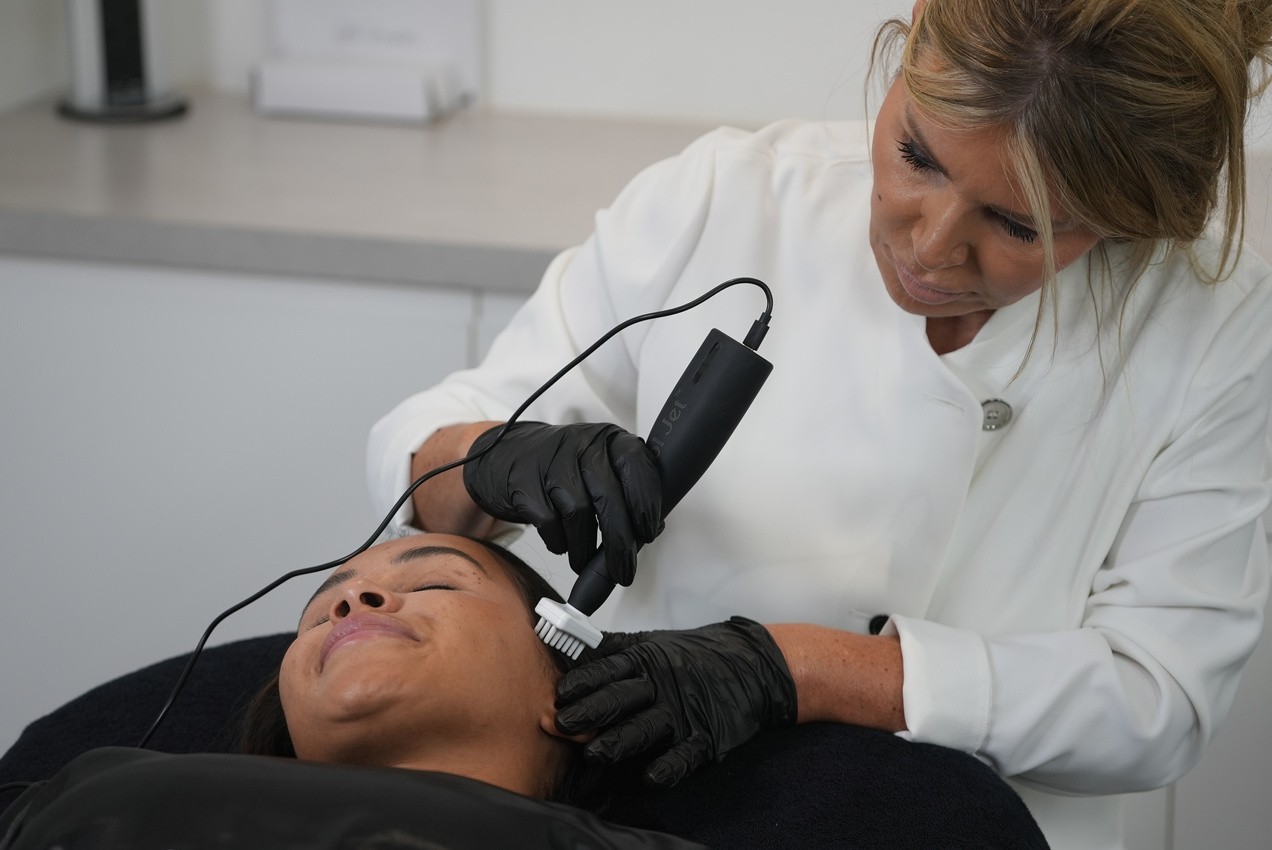 Practitioner delivering a plasma scalp session